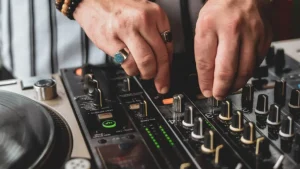 A DJ mixing music on a mixer.