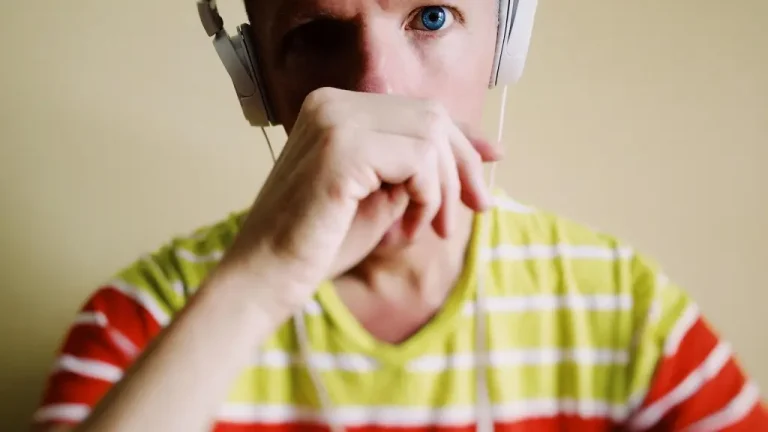 Man listening to headphones with thoughts on his mind.
