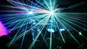 Packed dancefloor at Trade nightclub, London, with the logo visible. The image represents the 90s UK Hard House scene.